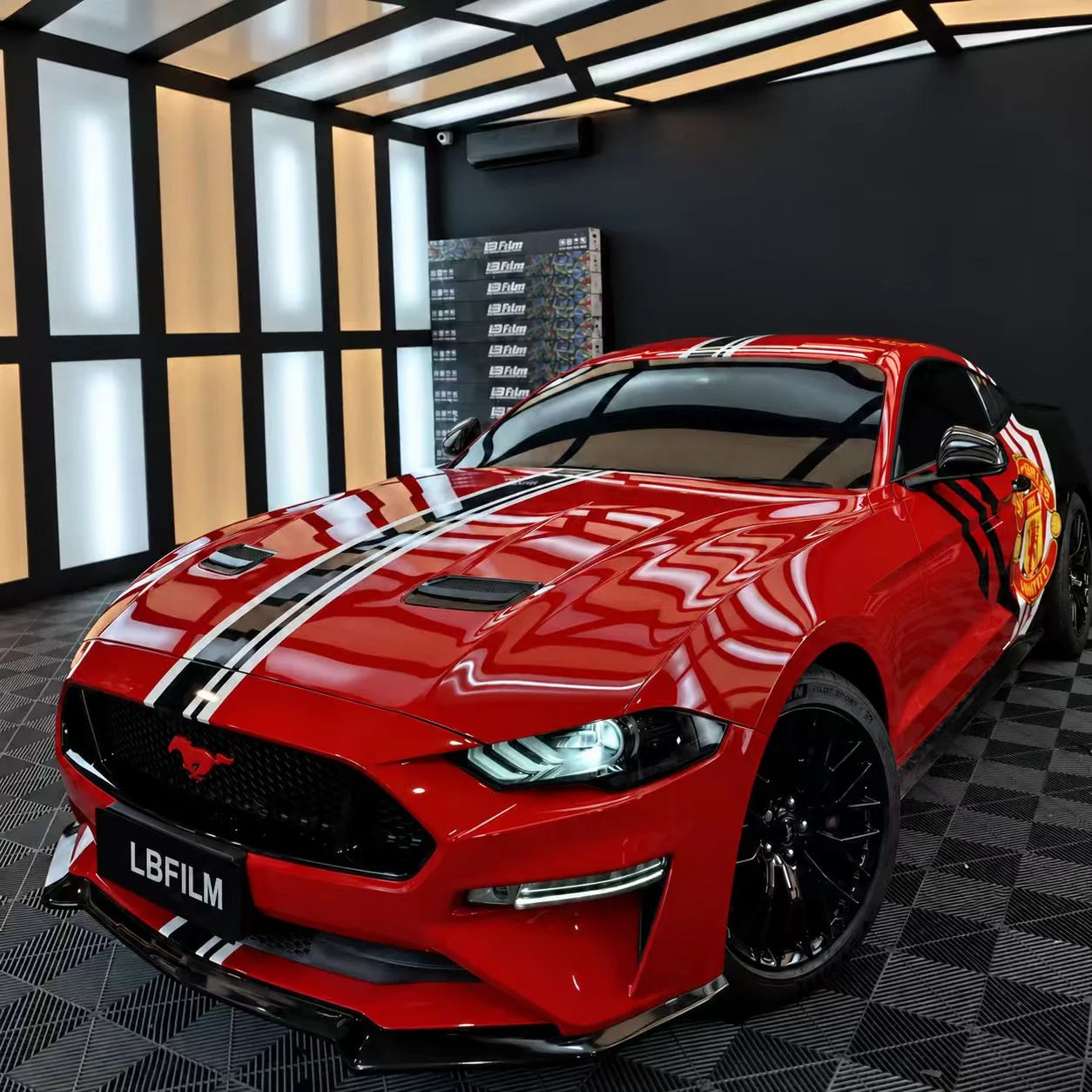 Red Ford Mustang with custom graphics in the LBFILM workshop