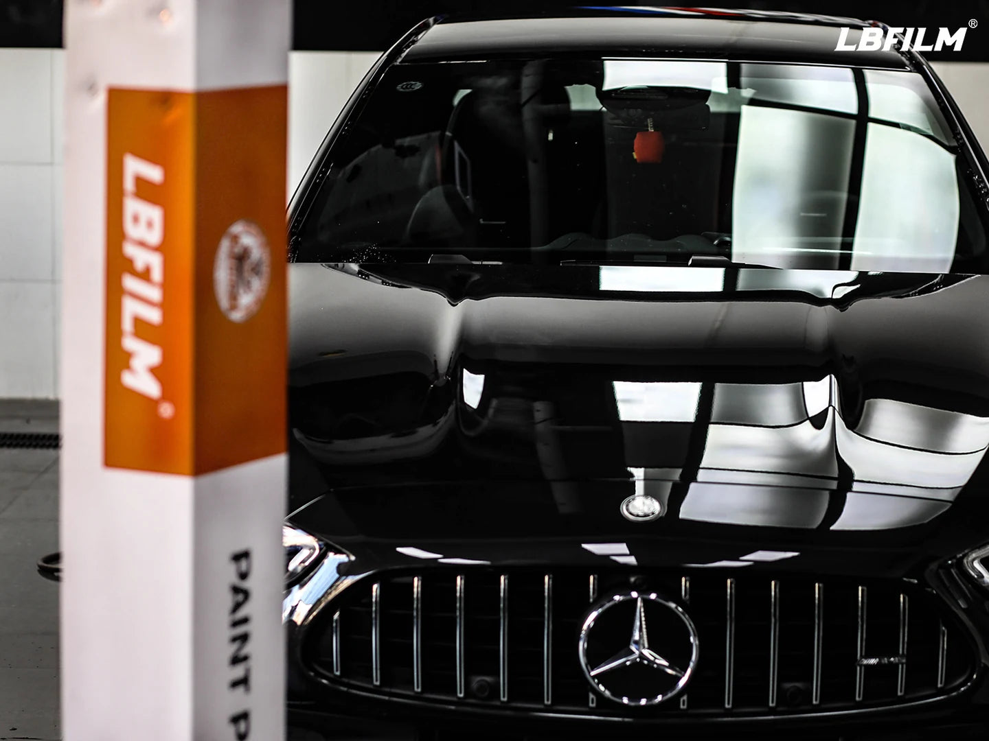 Black Mercedes paint finish with LBFILM K100 paint protection film packaging